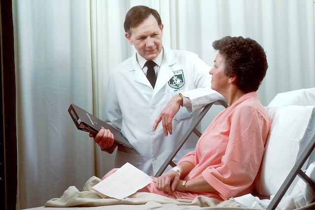 patient talking to doctor on the bed